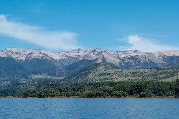 View of the Lake in the mountains in spring. Patagonian Coast Lake. Waves on the coast. Peninsula. Vertical Panoramic View. Vertical photo.	

