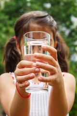 Child drinking pure water in nature.selectiv fokus