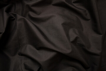 Black silk background, fabric texture, satin material. Christmas elegant abstract backdrop