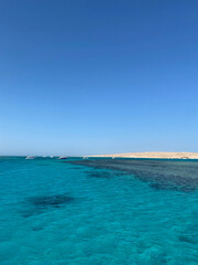 Yachts sail to the coral reef.  Boat trip.  Blue sea and sandy island.