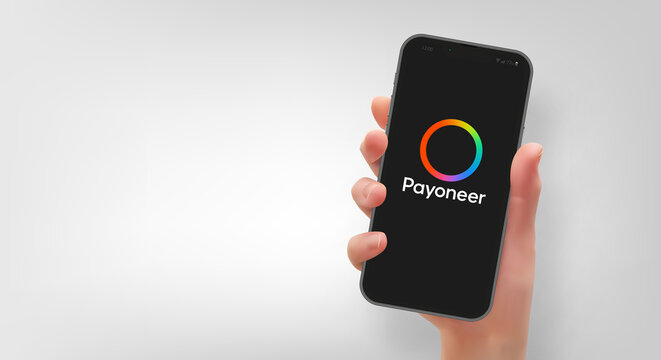 Woman hand holding the smartphone with logo Payoneer, vector editorial illustration
