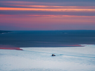 Scientific research vessel, breaks its way in the ice of the White Sea. View from above.