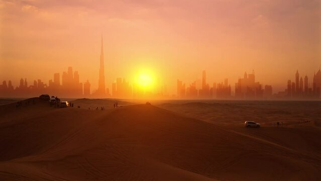 Aerial. Drone view of tourists looks on the sunset and Dubai city silhouette at the desert and epic sun.