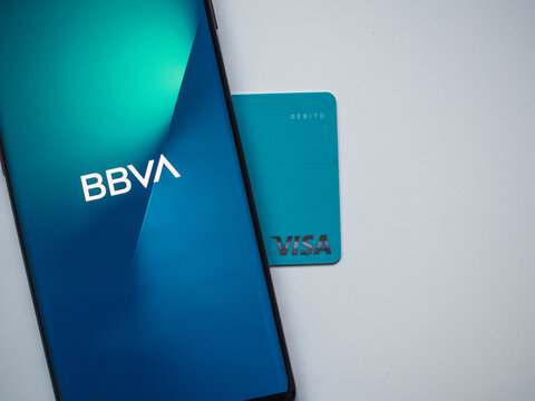 Marbella, Spain: January 21, 2022: BBVA app on smartphone and VISA card with white background and copy space