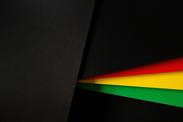 Black History Month color background. African American history month celebration. Abstract red, yellow, green color flag on black paper background