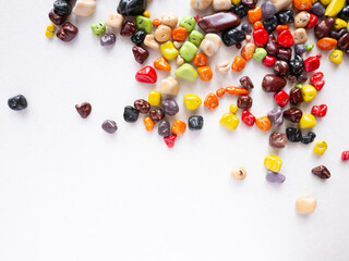 Candy multi-colored stones scattered on a white background