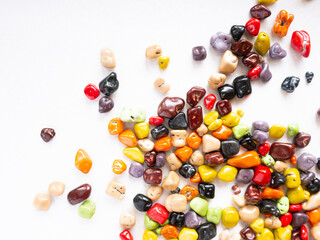 Candy multi-colored stones scattered on a white background