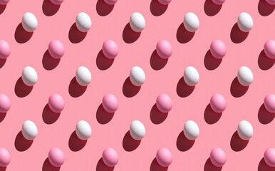 White and pink eggs with a hard shadow on a pink background.