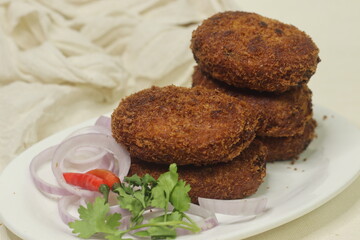 Deep fried Chicken Cutlets. A flat croquette of minced meat covered in bread crumbs and fried