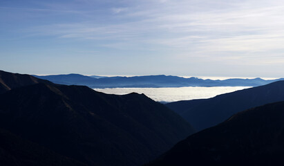 clouds over the mountains.
evening soft lights in mountains.