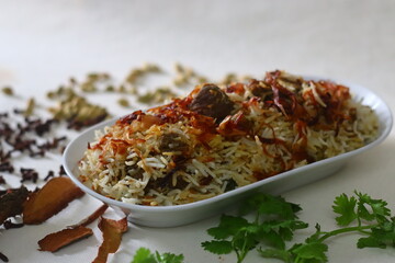 Mutton Biryani. A dish cooked with spices layered between mildly spiced ghee rice with a generous sprinkle of caramelized onions and Mutton marinated in yogurt
