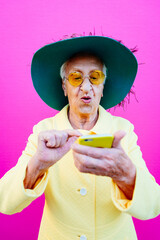 Funny grandmother portraits. Senior old woman, interacting with a smartphone. Concept about...