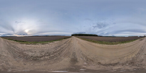 360 hdr panorama on no traffic yellow sand gravel road among fields with overcast sky with white clouds  in equirectangular spherical projection, VR AR content.  seamless