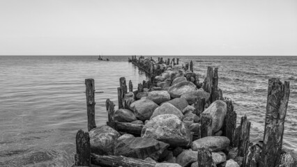 an old pier made of stones and wood