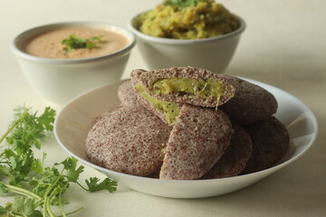 Potato stuffed ragi idli. Steamed finger millet cakes stuffed with smashed potato masala