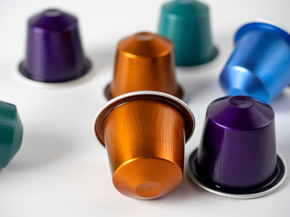 Colorful aluminum capsules with ground coffee on a white background. Capsules for the coffee machine