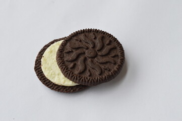 cocoa cookie with vanilla cream filling on a white background