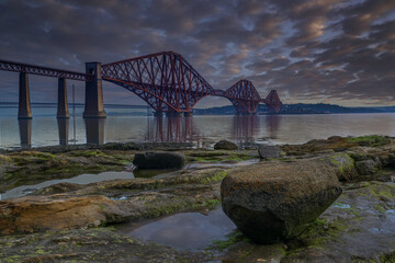 Forth Bridge at sunrise from South queensferry near Edinburgh Scotland.