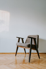 Armchair on wooden parquet - vertical photo