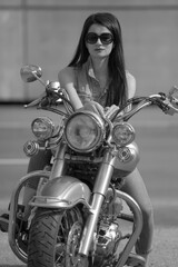 Fototapeta na wymiar Portrait of young woman on motorcycle