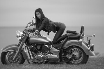 Obraz na płótnie Canvas Portrait of young woman on motorcycle