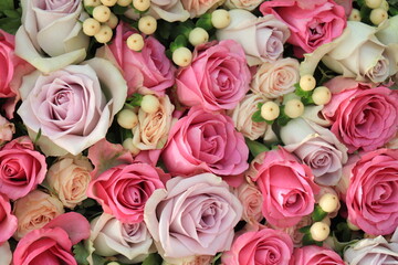 Pink and purple roses in a wedding centerpiece
