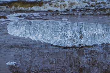 a piece of ice on the sea shore