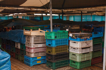 Empty market stall with lots of crates - obrazy, fototapety, plakaty