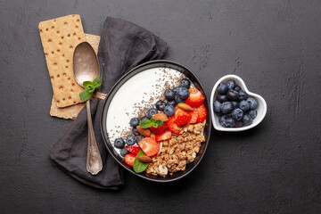 Healthy breakfast with bowl of granola, yogurt and fresh berries