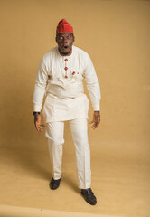 Yoruba Culturally Dressed Business Man bending forward in shock