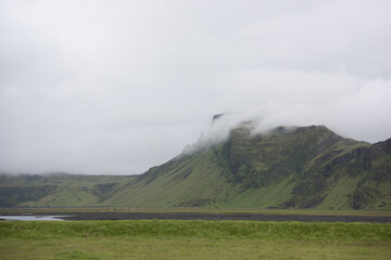 Green Grassy mountain Landscape in the highlands. Travel and nature on a beautiful cold day