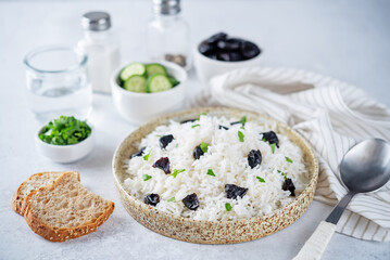 Prunes rice with parsley in a bowl