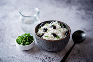 Prunes rice with parsley in a bowl