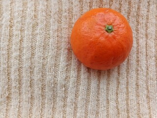 tangerine on a knitted background
