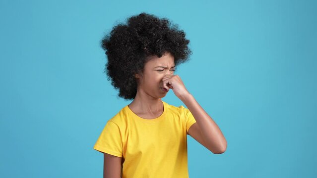 Kid girl ignore smelly stench hold breath isolated blue color background