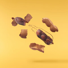Fresh ripe tamarind fruit falling in the air