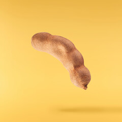 Fresh ripe tamarind falling in the air