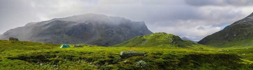 Panoramic view of camper in mountain landscape