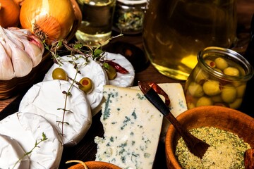Ingredients for the production of pickled cheese. Marinated camembert and greek feat cheese in oil. Traditional culinary cheese eating.