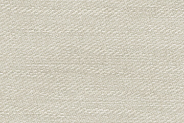 Macro photo of ecru jeans material. Fabric background.