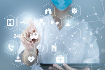 Doctor working with digital tablet on a virtual screen behind the structure of medical icons, health care concept