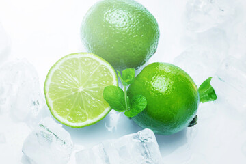 Fresh lime fruits with mint and ice cubes