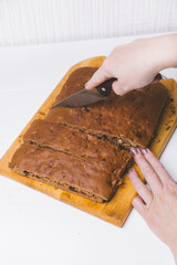 delicious homemade chocolate cake with honey and nuts on white plate 