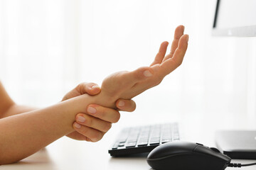 Female hands with a pain in the wrist because of carpal tunnel syndrome