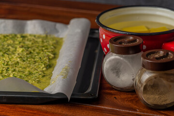 Preparing of courgette roll with ham and bacon and cheese with potatoes