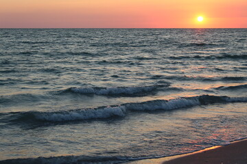 sunset on the beach with waves