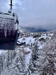 Ski lift with a ski village view on a snowy day 