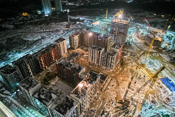 Construction of residential buildings at night.