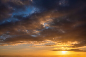 A beautiful, cloudy sunset sky with orange colors as texture or background