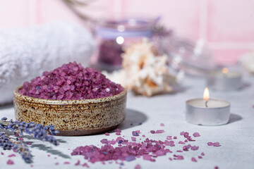 Fototapeta na wymiar Purple bath salt with lavender, towel and candles